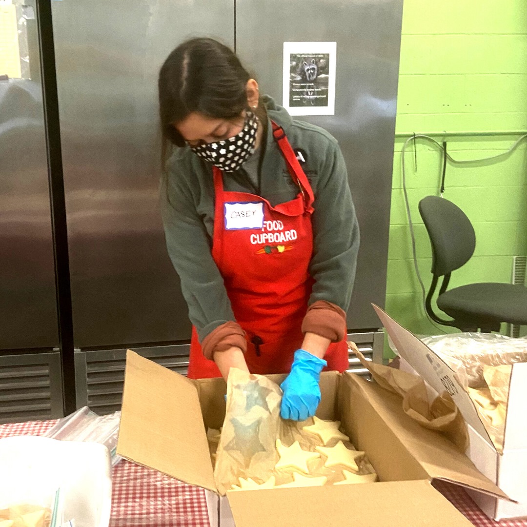 Person wrapping dough in a warehouse