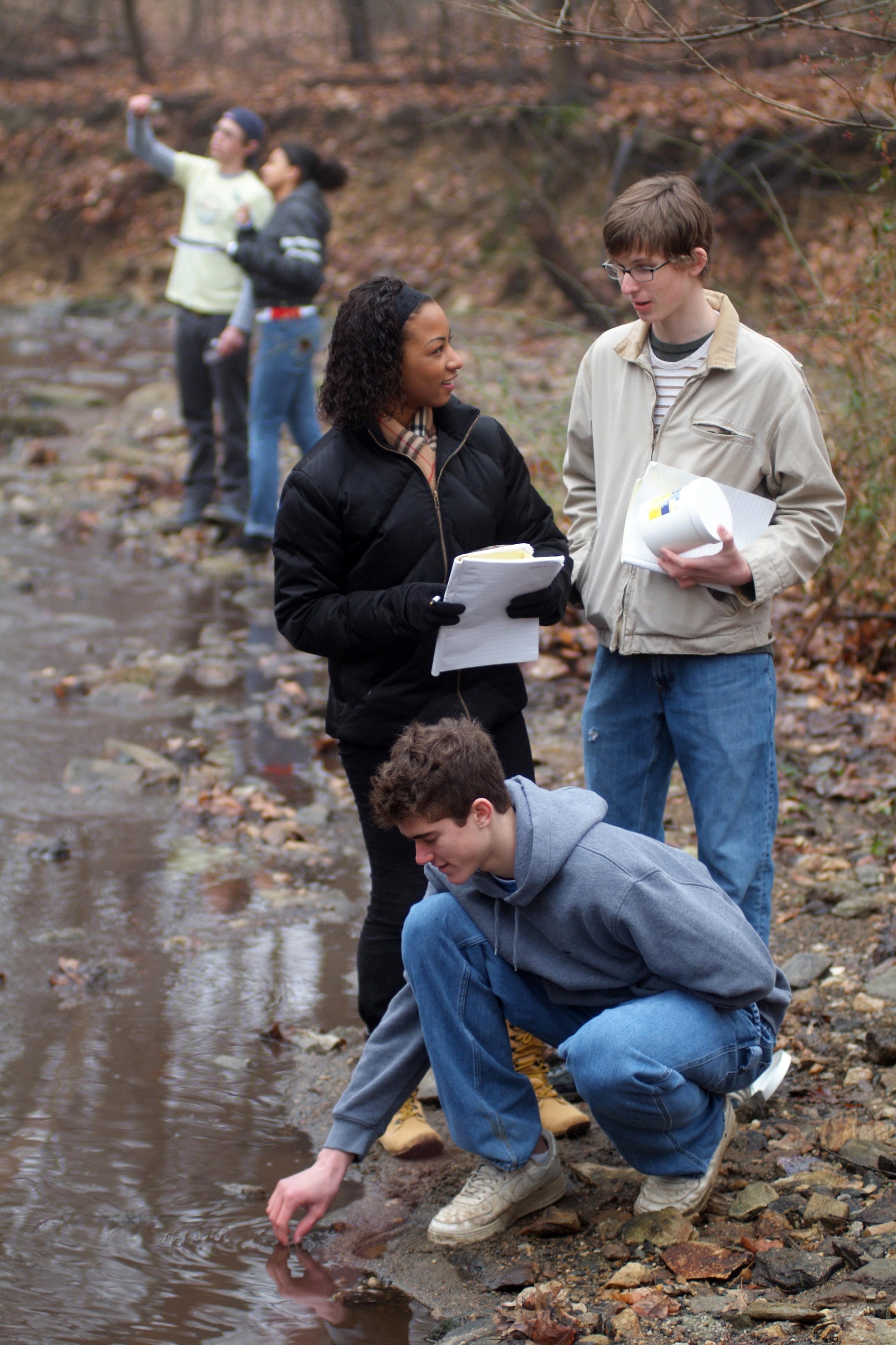youth and young adults collecting water samples