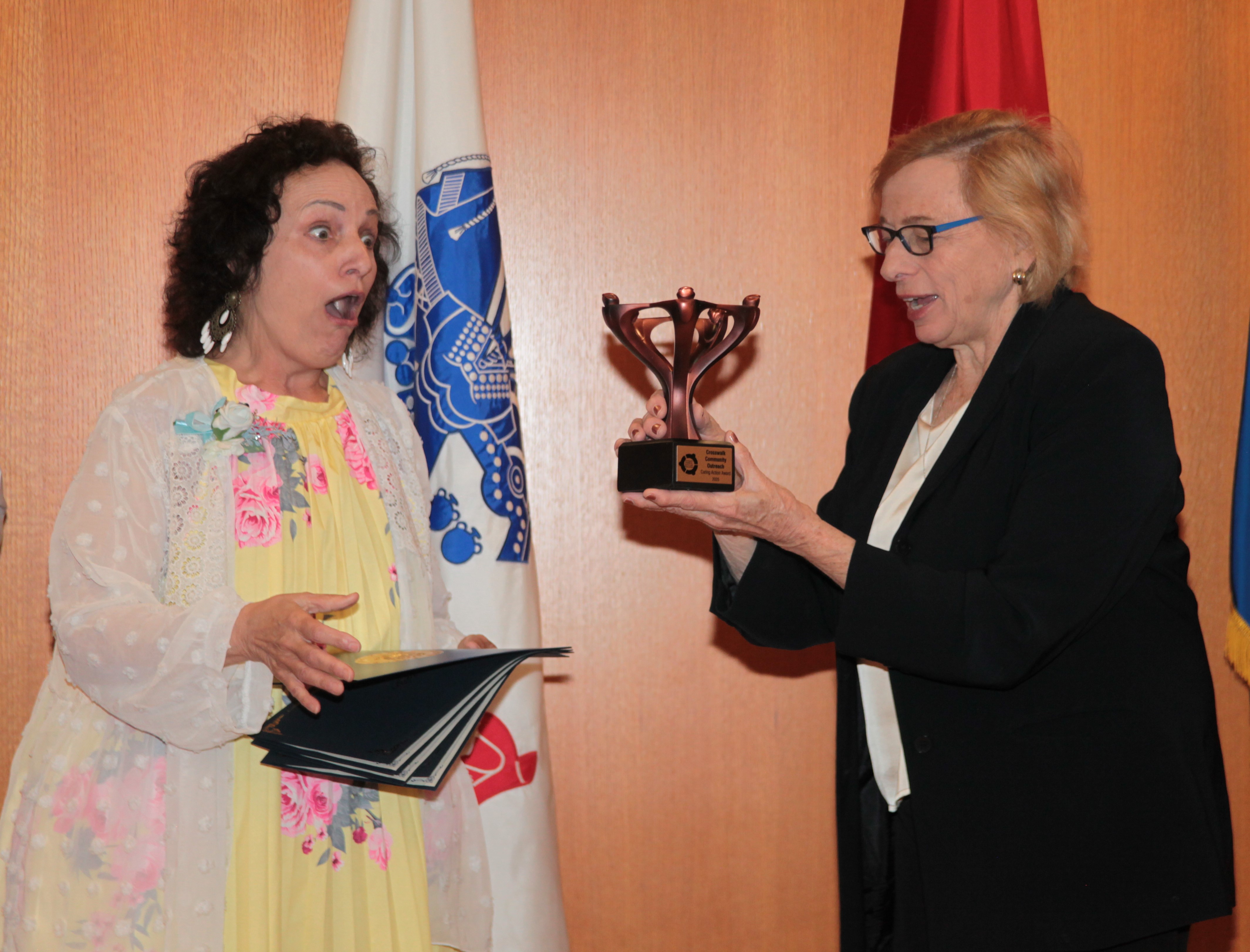 Image of 2025 GSA Recipient looking shocked and amazed receiving an award from Governor Janet Mills